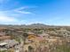 Aerial view of a single-story house with a large backyard and mountain views at 24002 S 201St Ct, Queen Creek, AZ 85142