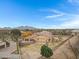 Aerial view showcasing a house's rear, highlighting its garage and expansive backyard at 24002 S 201St Ct, Queen Creek, AZ 85142
