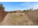 Large backyard with dirt, sparse grass, and trees at 24002 S 201St Ct, Queen Creek, AZ 85142