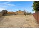 Large backyard with dirt, sparse grass, and trees at 24002 S 201St Ct, Queen Creek, AZ 85142