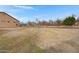 Large backyard with dirt, sparse grass, and trees at 24002 S 201St Ct, Queen Creek, AZ 85142