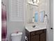 Clean bathroom with dark brown vanity, white sink, and a large mirror at 24002 S 201St Ct, Queen Creek, AZ 85142