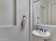 Small powder room with pedestal sink and mirror at 24002 S 201St Ct, Queen Creek, AZ 85142