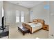 Spacious bedroom with wood bed frame and ensuite bathroom access at 24002 S 201St Ct, Queen Creek, AZ 85142
