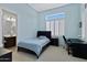 Light and airy bedroom with a bed, desk, and chair, plus an ensuite bath at 24002 S 201St Ct, Queen Creek, AZ 85142
