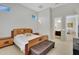 Spacious bedroom with wood bed frame and ensuite bathroom access at 24002 S 201St Ct, Queen Creek, AZ 85142
