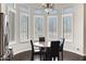 Bright breakfast nook with a round table and four chairs, surrounded by windows at 24002 S 201St Ct, Queen Creek, AZ 85142