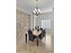 Elegant dining room with a stone accent wall and marble table at 24002 S 201St Ct, Queen Creek, AZ 85142