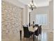 Modern dining room showcasing a stone accent wall at 24002 S 201St Ct, Queen Creek, AZ 85142