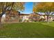 Stone and stucco house with autumn trees and landscaping at 24002 S 201St Ct, Queen Creek, AZ 85142
