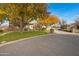 Stone house with autumn trees and paved driveway at 24002 S 201St Ct, Queen Creek, AZ 85142
