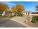 Tuscan style home with stone facade, driveway and landscaping at 24002 S 201St Ct, Queen Creek, AZ 85142