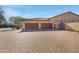 Three-car garage with brick-paved driveway, set against a bright sky at 24002 S 201St Ct, Queen Creek, AZ 85142