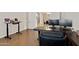 Spacious home office with L-shaped desk and hardwood floors at 24002 S 201St Ct, Queen Creek, AZ 85142