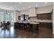 Gourmet kitchen boasts granite countertops, dark wood cabinets, and stainless steel appliances at 24002 S 201St Ct, Queen Creek, AZ 85142
