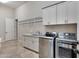 Laundry room with washer, dryer, cabinets, and sink at 24002 S 201St Ct, Queen Creek, AZ 85142