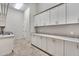 Bright laundry room with ample counter and cabinet space at 24002 S 201St Ct, Queen Creek, AZ 85142