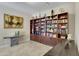 Library with extensive built-in shelving and artwork at 24002 S 201St Ct, Queen Creek, AZ 85142