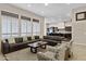Open living room with sectional sofa and kitchen view at 24002 S 201St Ct, Queen Creek, AZ 85142