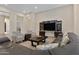 Relaxing living room featuring a sectional sofa and coffee table at 24002 S 201St Ct, Queen Creek, AZ 85142