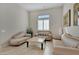 Cozy sitting room with striped couches and a marble-top coffee table at 24002 S 201St Ct, Queen Creek, AZ 85142