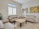 Cozy sitting room with striped couches and a marble-top coffee table at 24002 S 201St Ct, Queen Creek, AZ 85142