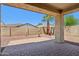Private backyard featuring a brick patio and desert landscaping, perfect for outdoor living at 2542 N Riley Rd, Buckeye, AZ 85396