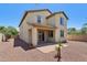 The backyard has desert landscaping and shows a sliding glass door and two stories at 2542 N Riley Rd, Buckeye, AZ 85396