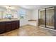 Bathroom featuring tile flooring, a glass shower enclosure, soaking tub and dark vanity at 2542 N Riley Rd, Buckeye, AZ 85396