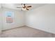 This is a bedroom with a ceiling fan and a window at 2542 N Riley Rd, Buckeye, AZ 85396
