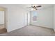 This is a bedroom with carpeted floors, a window, and a ceiling fan at 2542 N Riley Rd, Buckeye, AZ 85396