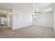 Spacious bedroom featuring neutral carpeting, a ceiling fan, and a window that provides natural light and outdoor views at 2542 N Riley Rd, Buckeye, AZ 85396