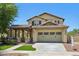 Charming two-story home with a desert landscape, a covered porch, and a two-car garage at 2542 N Riley Rd, Buckeye, AZ 85396