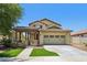 Charming two-story home featuring a covered porch and an attached two-car garage at 2542 N Riley Rd, Buckeye, AZ 85396