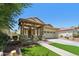 Attractive two-story home with a two-car garage, covered porch, and well-manicured front yard at 2542 N Riley Rd, Buckeye, AZ 85396