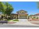 Spacious home showcasing a landscaped front yard, covered porch, and an attached two-car garage at 2542 N Riley Rd, Buckeye, AZ 85396