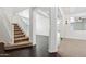 Open foyer featuring hardwood floors, arched doorways, a staircase, and natural light at 2542 N Riley Rd, Buckeye, AZ 85396