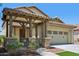 The front porch features stone accents and a covered entrance with wood beams at 2542 N Riley Rd, Buckeye, AZ 85396