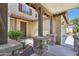 Covered front porch with stone pillars and wood supports, offering a welcoming entrance to the home at 2542 N Riley Rd, Buckeye, AZ 85396