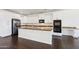 Bright kitchen with white cabinetry, stainless steel appliances, and a large center island at 2542 N Riley Rd, Buckeye, AZ 85396