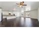 Spacious kitchen with white cabinets, an island with a sink, and modern appliances leading to outdoor access at 2542 N Riley Rd, Buckeye, AZ 85396