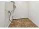 A compact laundry room with tile flooring, hookups, a shelf, and white walls at 2542 N Riley Rd, Buckeye, AZ 85396