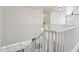 Bright staircase with white railings leads to the upper level, showcasing modern design and abundant natural light at 2542 N Riley Rd, Buckeye, AZ 85396