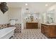 Elegant bathroom features a freestanding tub, dual sinks with wooden cabinets, patterned floor tiles, and ample lighting at 4531 E Quartz Mountain Rd, Paradise Valley, AZ 85253