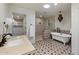Bright bathroom featuring a modern shower, standalone tub, patterned floor tiles, and a spacious walk-in closet at 4531 E Quartz Mountain Rd, Paradise Valley, AZ 85253