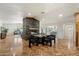 Open-concept dining area with a stone fireplace, wood flooring, and a table for gatherings and entertaining at 4531 E Quartz Mountain Rd, Paradise Valley, AZ 85253