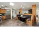 Open kitchen with a dining nook, stainless steel appliances, rustic cabinetry, and skylight for natural light at 4531 E Quartz Mountain Rd, Paradise Valley, AZ 85253