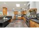 Bright kitchen with skylight, farmhouse sink, stainless steel appliances, and rustic wood cabinetry at 4531 E Quartz Mountain Rd, Paradise Valley, AZ 85253