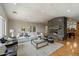 Bright living room featuring a stone fireplace, parquet floors, neutral decor and light gray walls at 4531 E Quartz Mountain Rd, Paradise Valley, AZ 85253