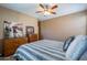 Spacious bedroom with wood dresser and ceiling fan at 4718 E Thunderheart Trl # 103, Gilbert, AZ 85297